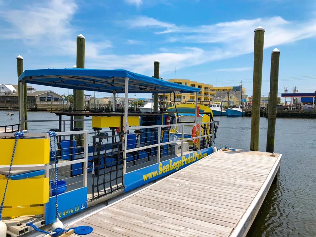 A pedal boat sits docked on the water near surrounding buildings, evoking outdoor adventure, boating, fishing, and the easy transition to waterfront activities referenced in the section.